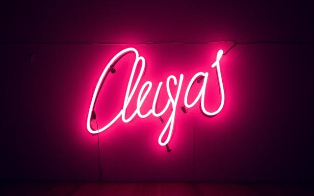 A vibrant, completed custom neon art piece glowing brilliantly on a dark wall, showcasing fine craftsmanship and artistic detail.