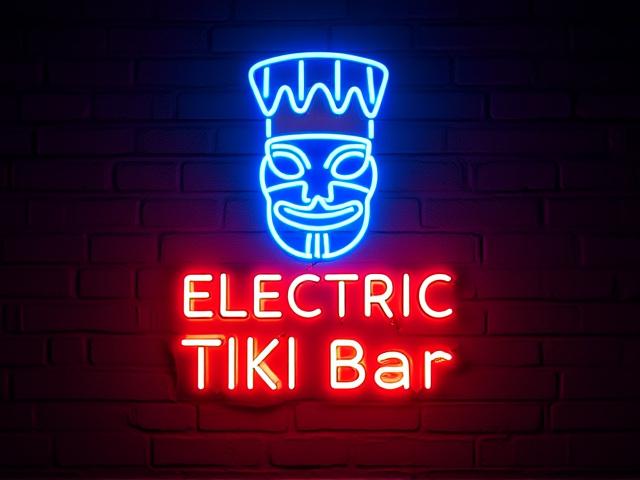 A bespoke retro neon logo for 'Electric Tiki Bar', featuring a blue tiki masked figure and red text, glowing against a dark, textured wall.